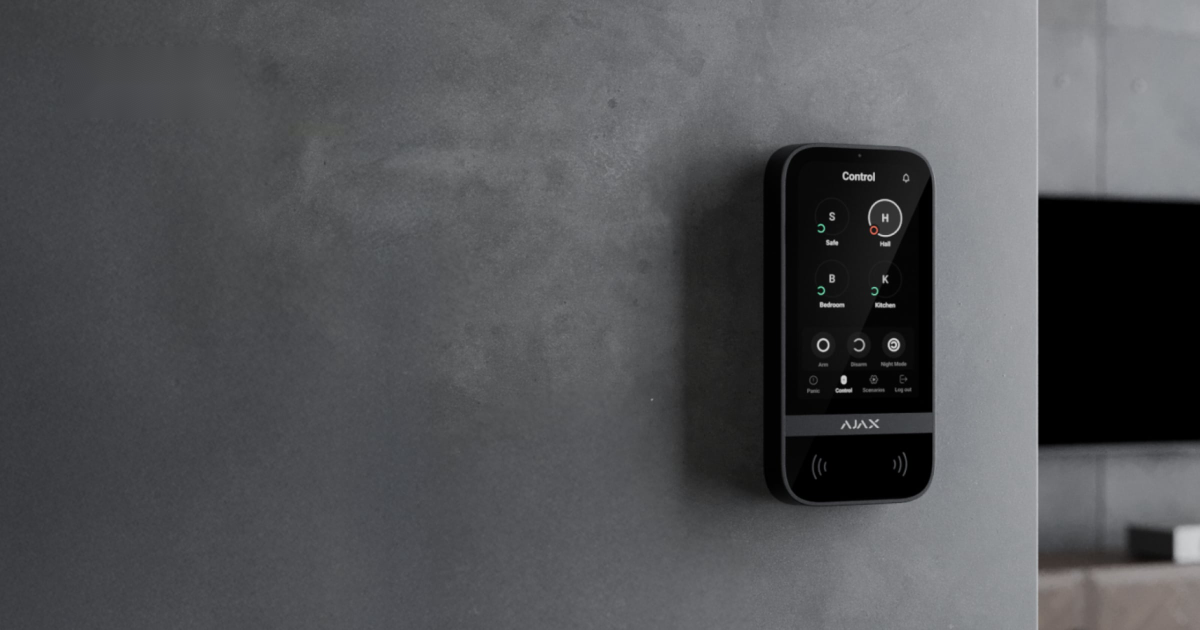 Sleek black Ajax touchscreen keypad mounted on a contemporary interior wall